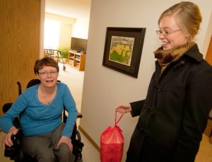 woman in wheelchair and delivery person